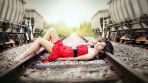Женщина в купальнике стоит на железнодорожных путях 9